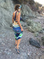 Woman in a colorful dress walking on a rocky trail