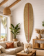 Living room with a surfboard wall art, sofa, and decorative items.